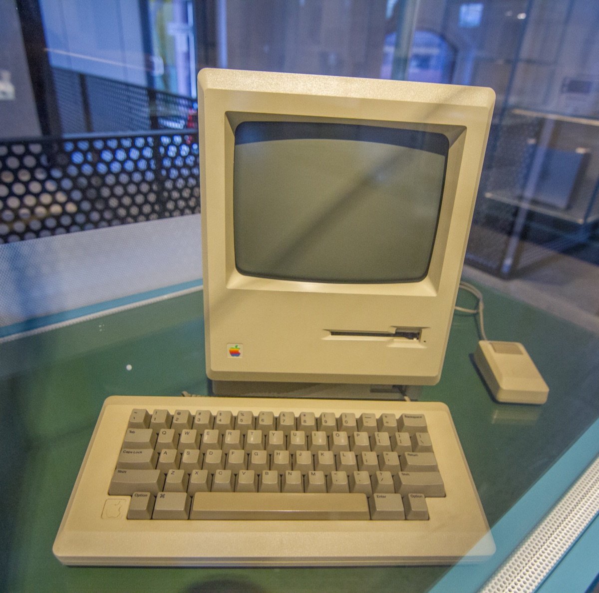 Early Apple Macintosh 128K with the original single-button mouse and keyboard on museum display