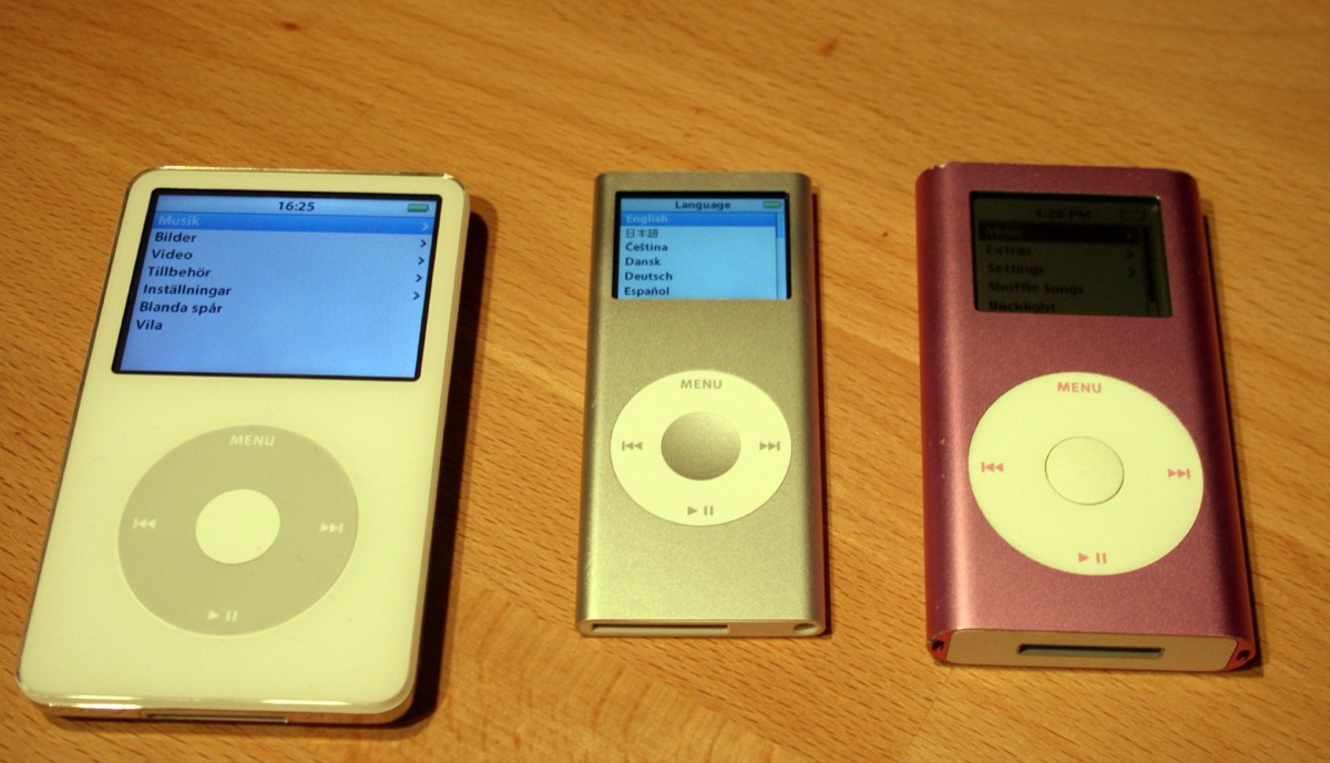 Three generations of iPod side by side: iPod 5G Video, iPod Nano 2nd gen, and iPod Mini 2nd gen