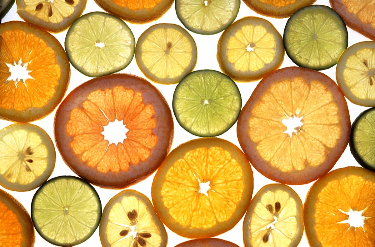 A colorful arrangement of vitamin-C-rich citrus fruits - oranges, grapefruit, lemon and lime - illustrating a study linking higher blood vitamin C to a healthier aging brain