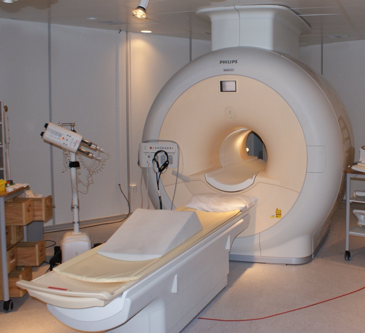 A magnetic resonance imaging (MRI) scanner in a clinical suite - a representative MRI machine illustrating research in which a metamaterial radiofrequency antenna made existing scanners produce sharper, faster images of the eye and brain (not the study's specific 7-tesla system).