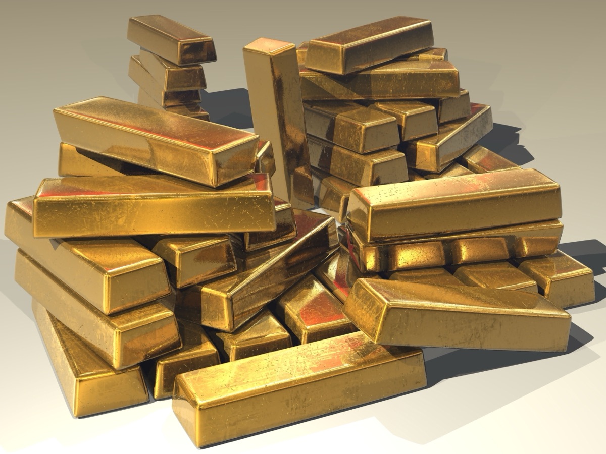 Stacked gold bullion bars, illustrating gold's legendary resistance to tarnishing - now explained by surface atoms that rearrange into a tight, oxygen-blocking hexagonal pattern (representative photo, not from the study).